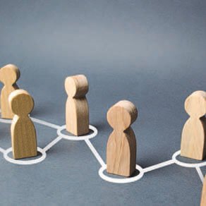 Wooden figures in an off center row