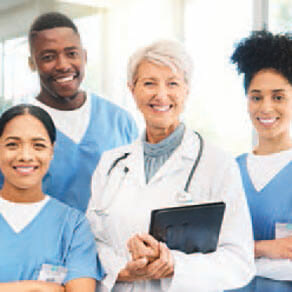 Group of doctors and medical professionals standing together smiling