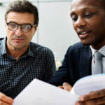 Two men looking at papers on estate planning