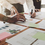 Business people analyzing financial documents for year end tax planning