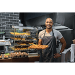 Baker in cafe' holding up full baking sheet