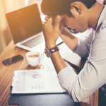 Man looking concerned at paperwork with chart on it