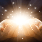 Two hands holding light and sparkles