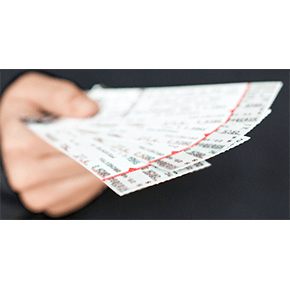 A person holding a bunch of concert tickets