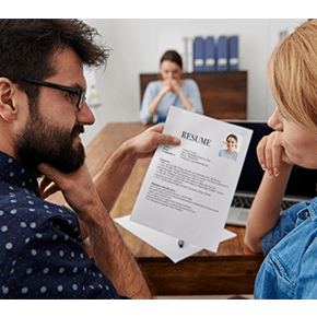 Two people questioning and reviewing resume